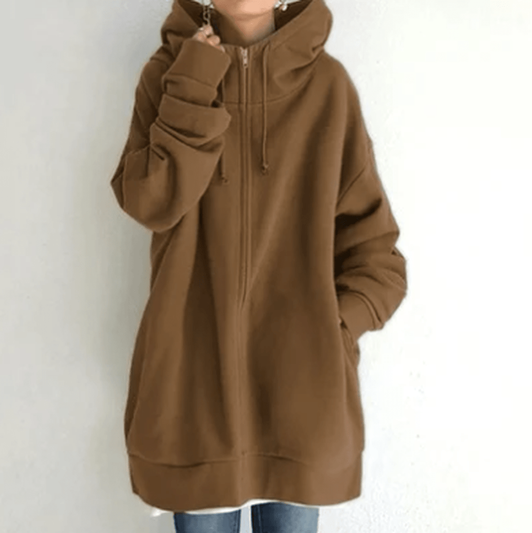 Side profile of a woman wearing a casual long sleeve zip-up jacket, soft and comfortable