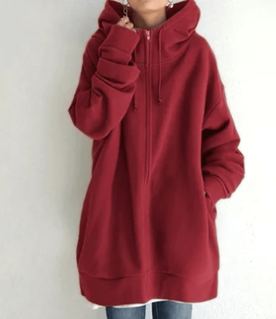 Detail of the hood and drawstring on a women's long sleeve zip-up jacket, functional design