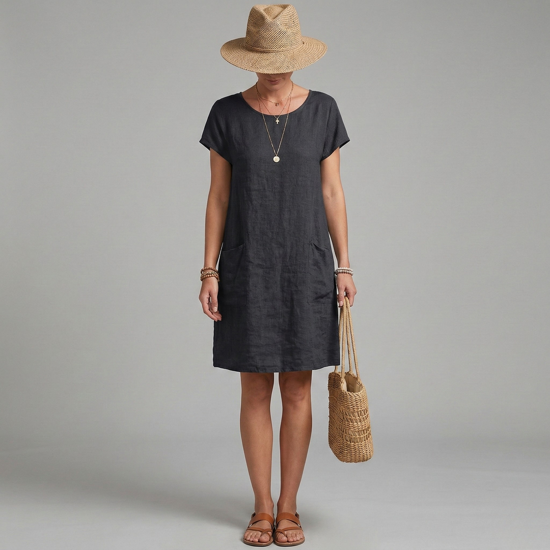 Relaxed fit women's shift mini dress, short sleeve, featuring practical front pockets. Great for spring & summer.
