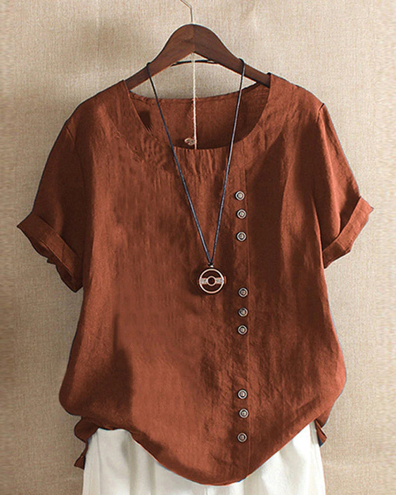 Model wearing a relaxed fit women's short sleeve blouse with button accents for a casual look