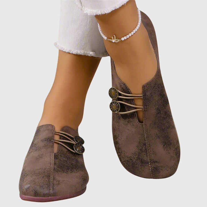 Women's casual slip-on flats in beige with button detail, perfect for spring and summer comfort