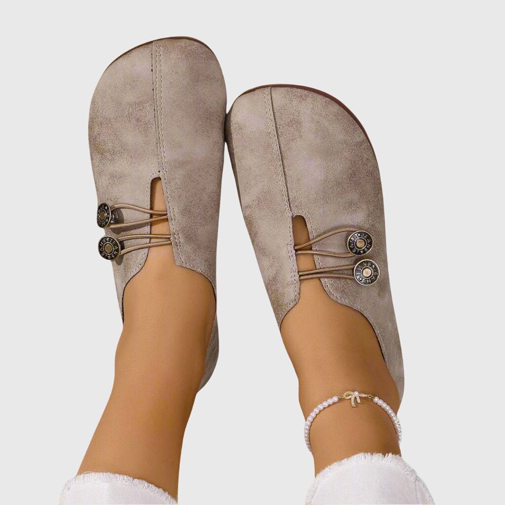 Close-up of a women's slip-on flat shoe, showcasing button detail and comfortable design