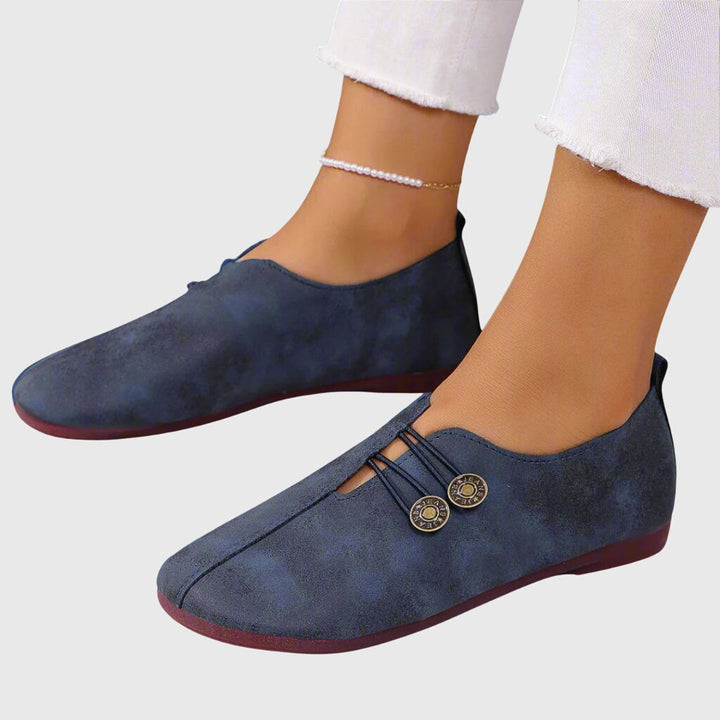 Stylish women's slip-on flats for spring and summer, featuring a decorative button on the strap