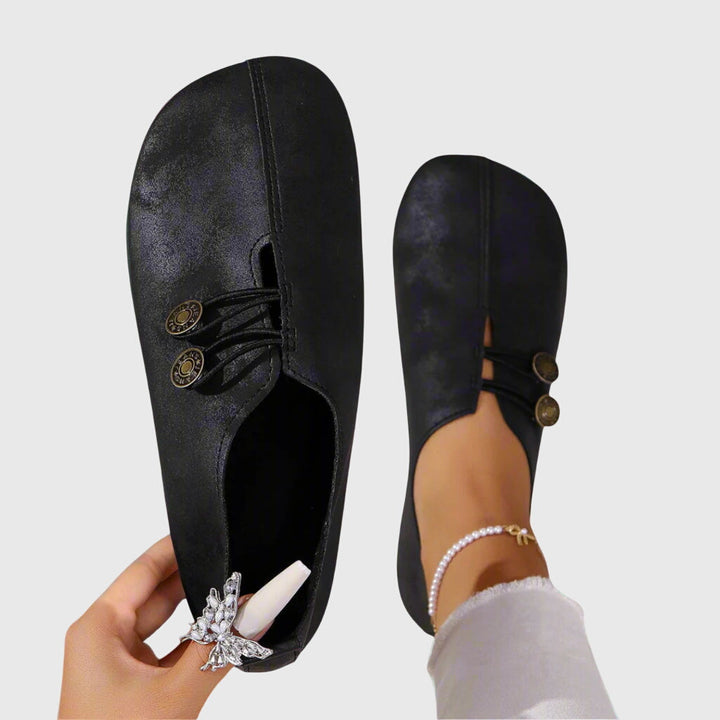 Pair of comfortable women's casual slip-on shoes with button accent, ideal for everyday wear