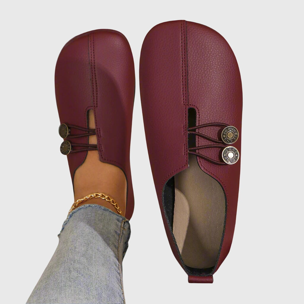 Front view of women's fashion slip-on flats, designed for comfort with a chic button embellishment