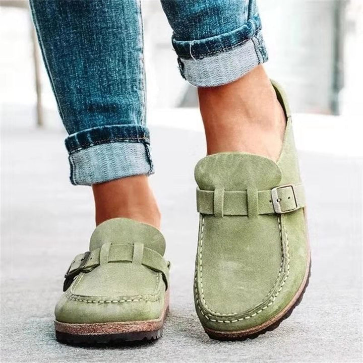 Stylish women's slip-on loafers featuring a prominent buckle, ideal for casual wear.