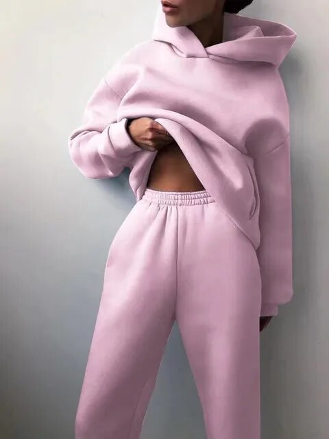 Model smiling in a comfortable women's casual loungewear two-piece set, effortless fashion.