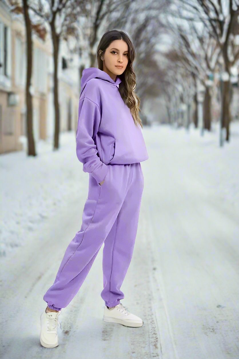 Woman relaxing in comfortable women's casual lounge two-piece set, cozy and fashionable.