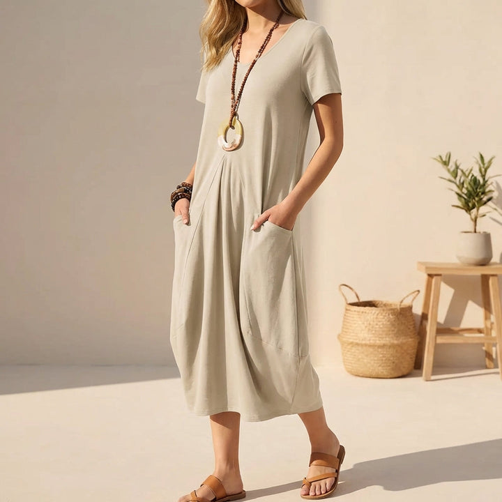 Women's casual V-neck midi dress with short sleeves & practical pockets, perfect for comfortable everyday wear.