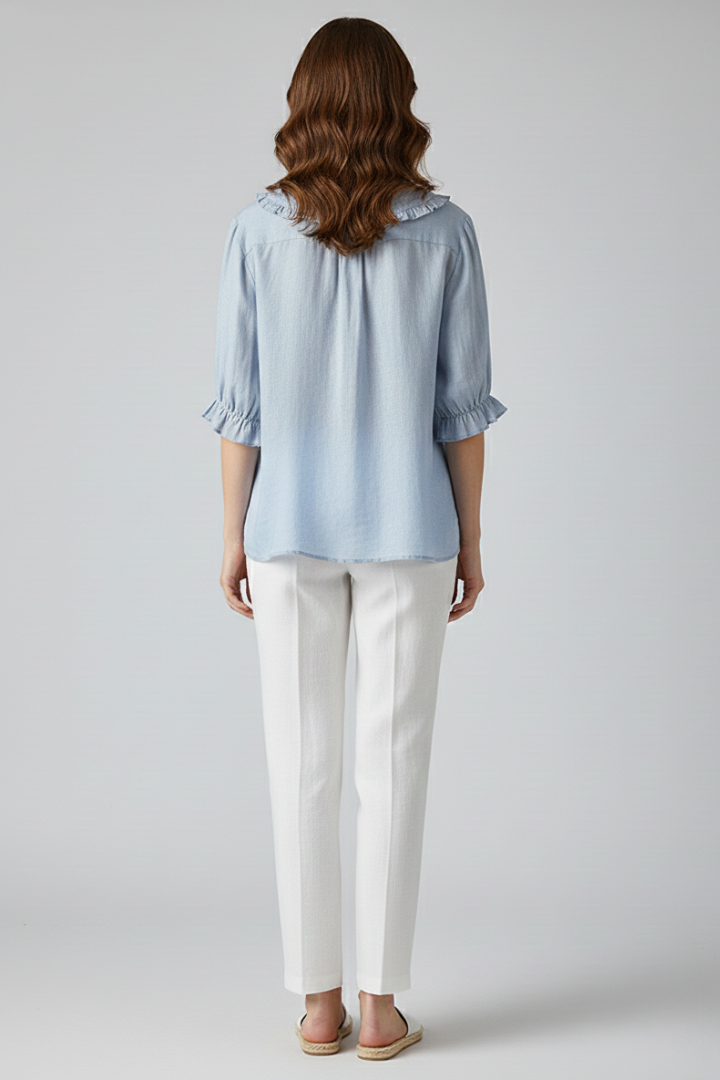 Close-up of a women's casual ruffled collar button-front shirt, showcasing fabric detail.
