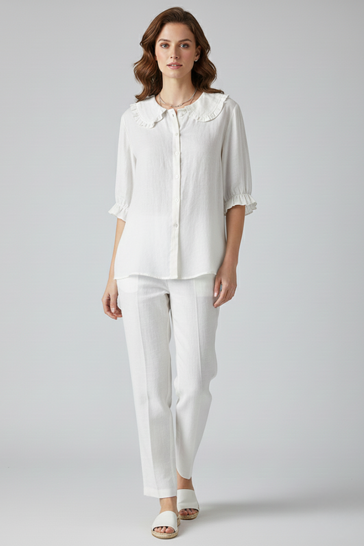 Full body view of a woman wearing a relaxed fit ruffled button-front shirt, perfect casual top.