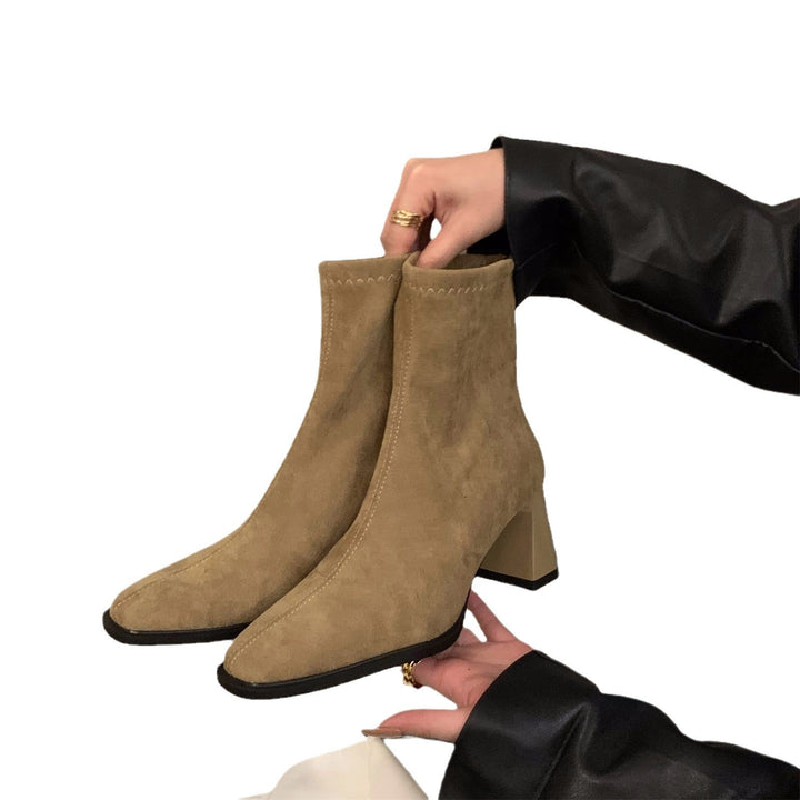 Black women's ankle boots with a comfortable block heel, pointed toe, and chic design. Perfect for versatile fashion.