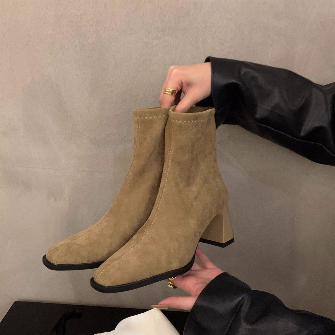 Elegant women's black ankle boots with a comfortable block heel and sharp pointed toe. Modern stylish everyday footwear.