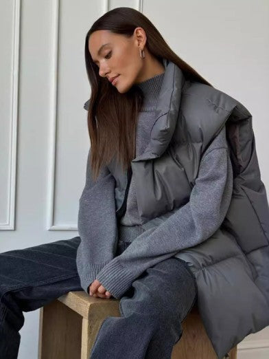 Women's chic black sleeveless puffer vest, perfect for winter layering & warmth. Trendy casual outerwear.