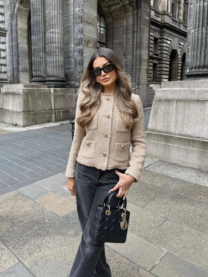 Women's chic black tweed cropped blazer, featuring a button-front closure, a key fashion jacket for spring aesthetics.