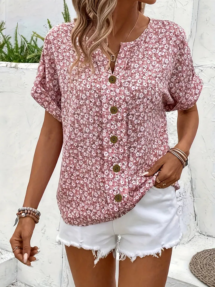 Stylish women's summer top featuring an eye-catching floral print, a versatile casual blouse