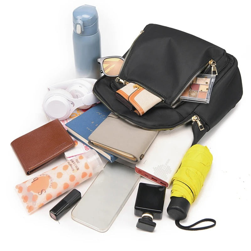 Elegant black women's PU leather travel backpack, featuring adjustable straps & a chic design.