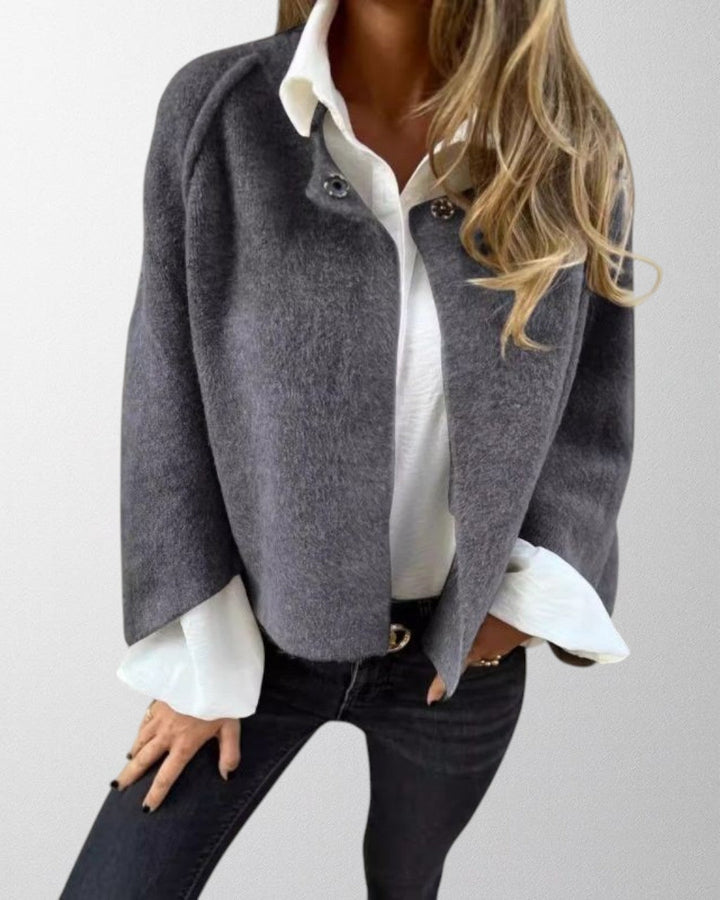 Elegant women's short jacket with stylish flared sleeves, a versatile fashion piece.