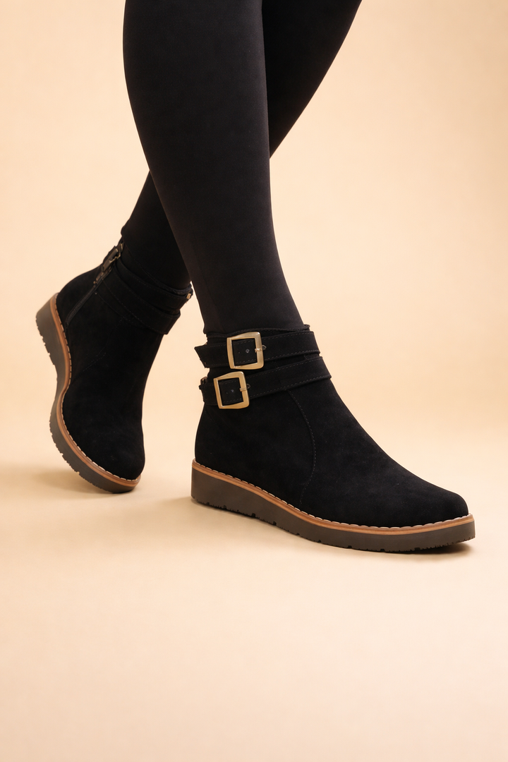 Women's black ankle boots with double buckle design & structured silhouette, great for winter fashion.