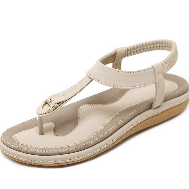 Close-up of women's comfortable T-strap sandals with soft cushioning and stretchy elastic heel strap.