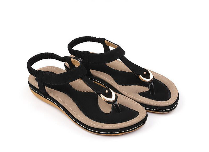 Versatile women's T-strap flat sandals, cushioned for comfort, with elastic back, perfect for casual summer style.