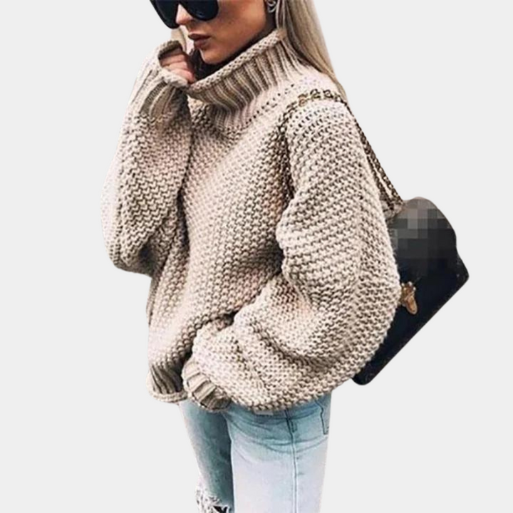 Comfortable women's relaxed fit sweater with a chunky knit and stylish high neck, ideal for layered looks.