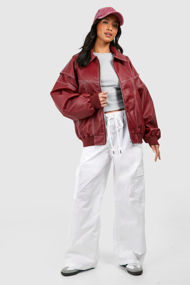 Detail of the zipper and collar on a women's faux leather bomber jacket, motorcycle style