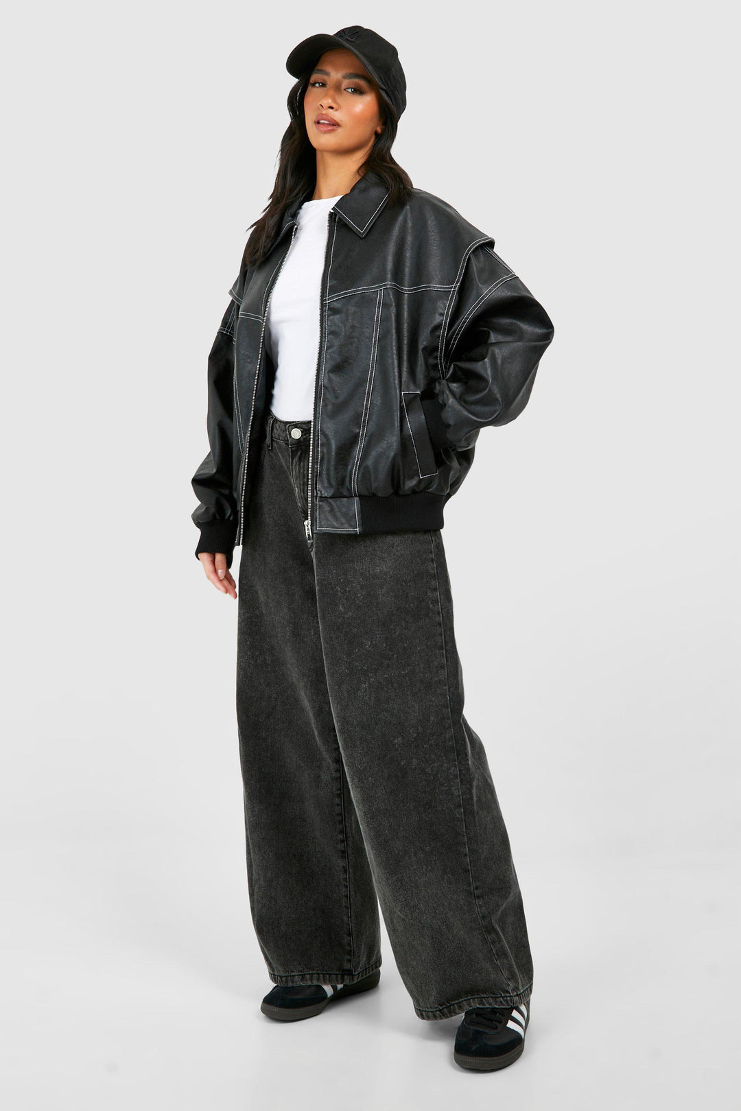 Woman posing in a classic faux leather bomber jacket, deep red color, fashion-forward