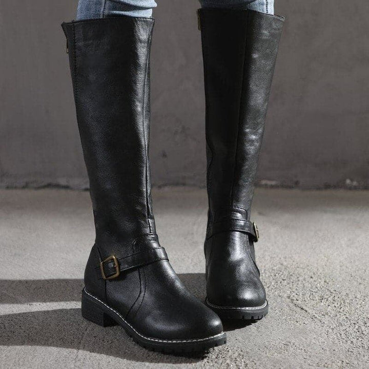 Stylish women's knee-high buckle boots, perfect for winter outfits and classic looks