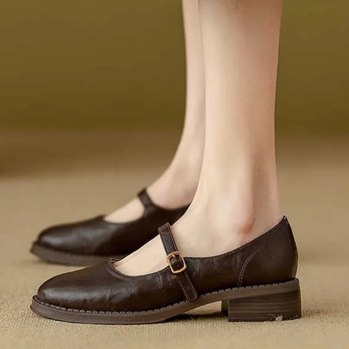 Women's stylish black leather Mary Jane flats with a secure buckle strap and low block heel