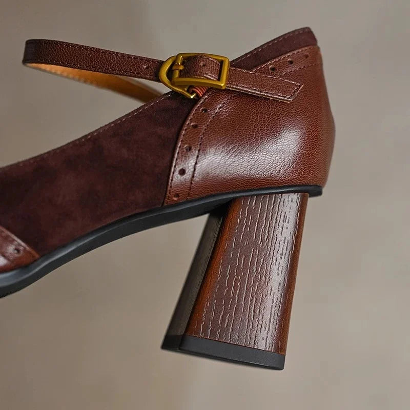 Classic women's office wear: black leather pumps with comfortable low heel, ankle strap, and square toe.