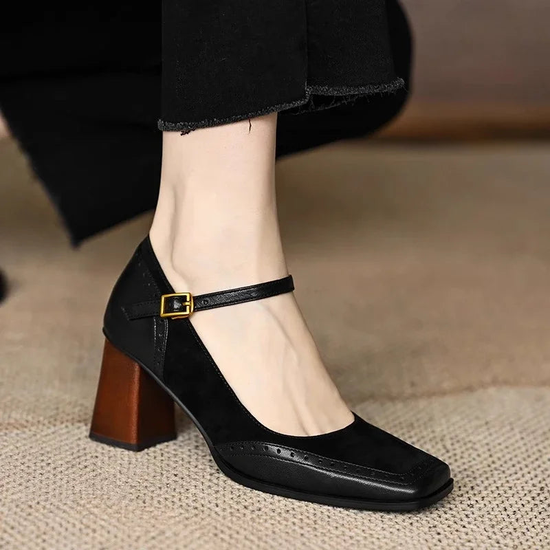 Elegant women's leather pumps featuring an ankle strap, square toe, low heel, and subtle brogue detail.