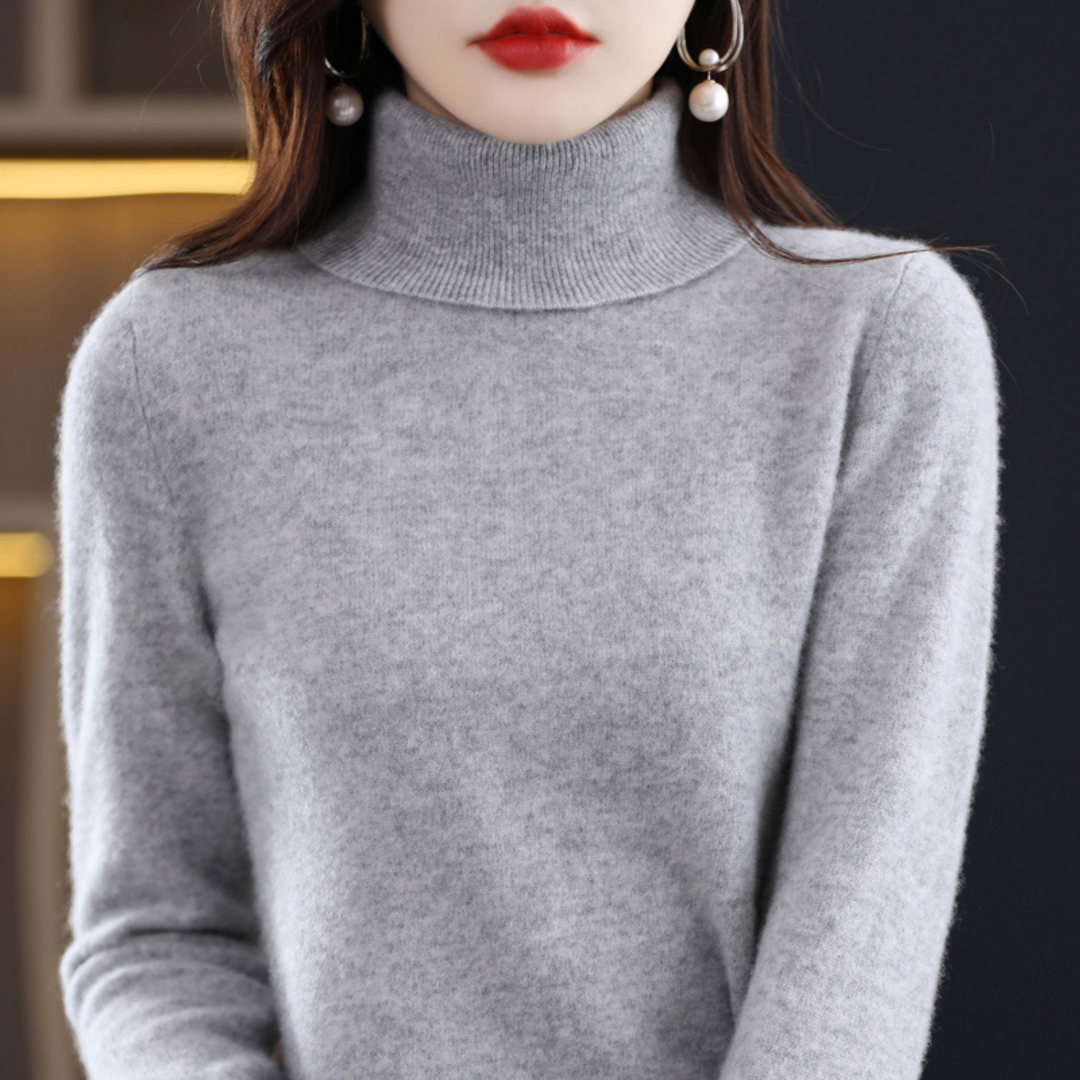 Stacked pile of various colored women's knit turtleneck sweaters, winter apparel