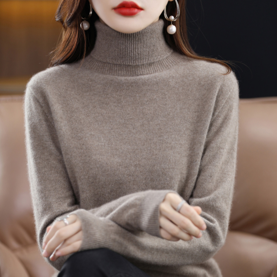 Close-up of the hem and cuff detailing on a women's classic knit turtleneck sweater