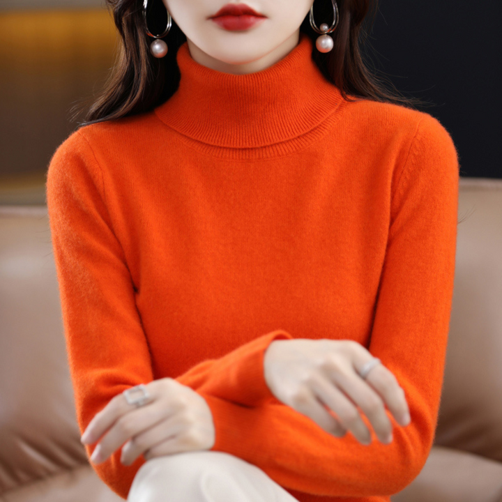 Full-length shot of a women's classic blue turtleneck knit sweater paired with jeans