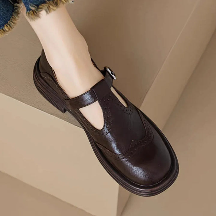 Sophisticated women's navy leather T-strap flat shoes with a buckle closure for classic style