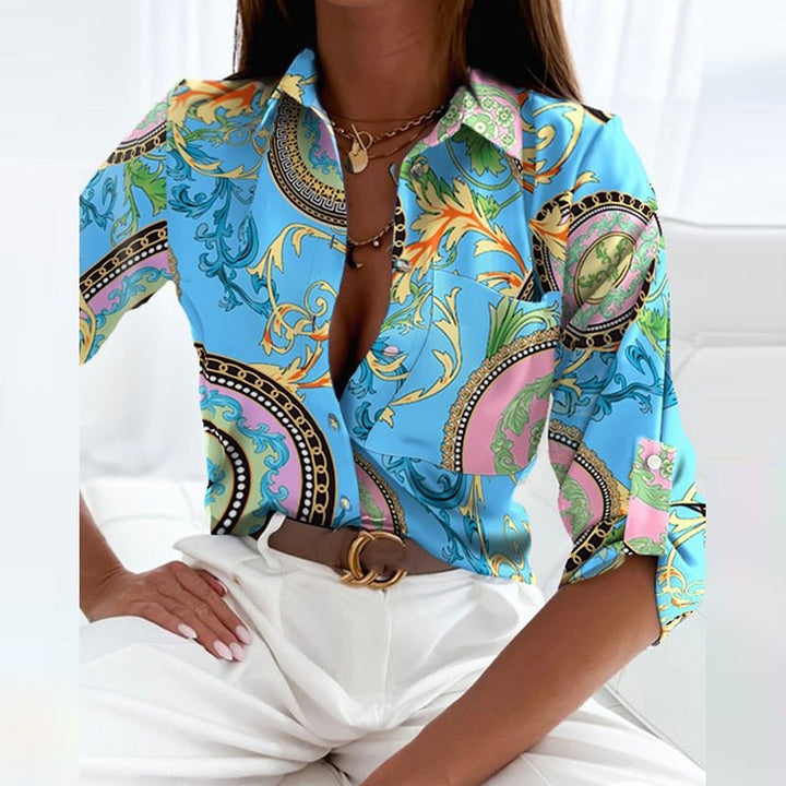 Long sleeve women's tailored blouse, highlighting cuff detail and elegant design.