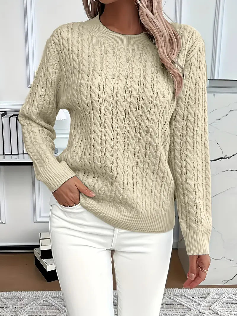 Elegant women's cable knit jumper in a light color, emphasizing its soft, luxurious texture.