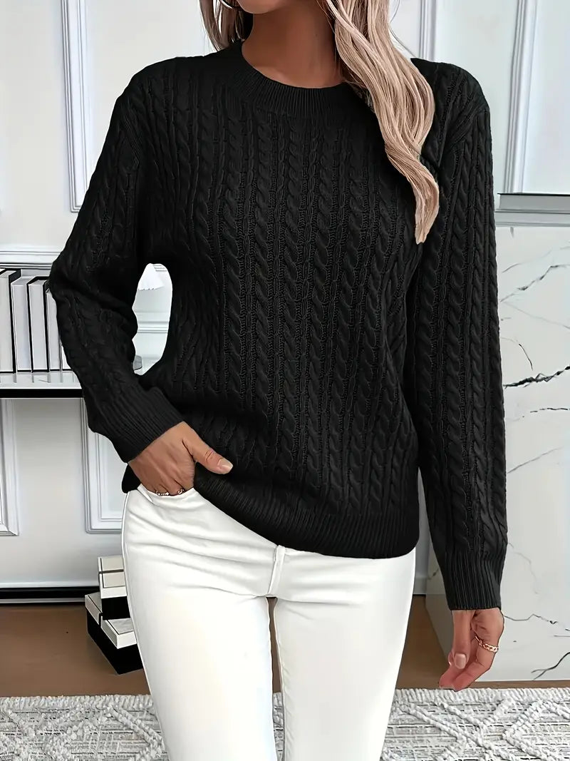 Detail of the soft knit fabric and cable pattern on a cozy ladies' oversized sweater.
