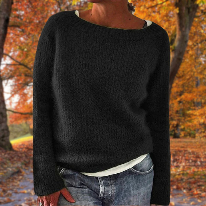 Close-up of a women's classic knit sweater, showing elegant texture & cozy warmth. Perfect for winter fashion.