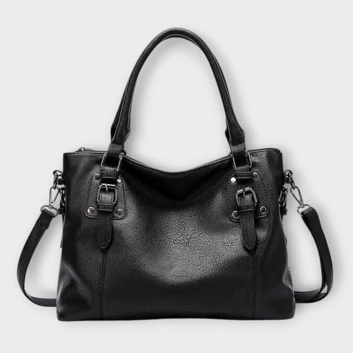 Close-up of women's fashion handbag, showing textured material and comfortable shoulder strap