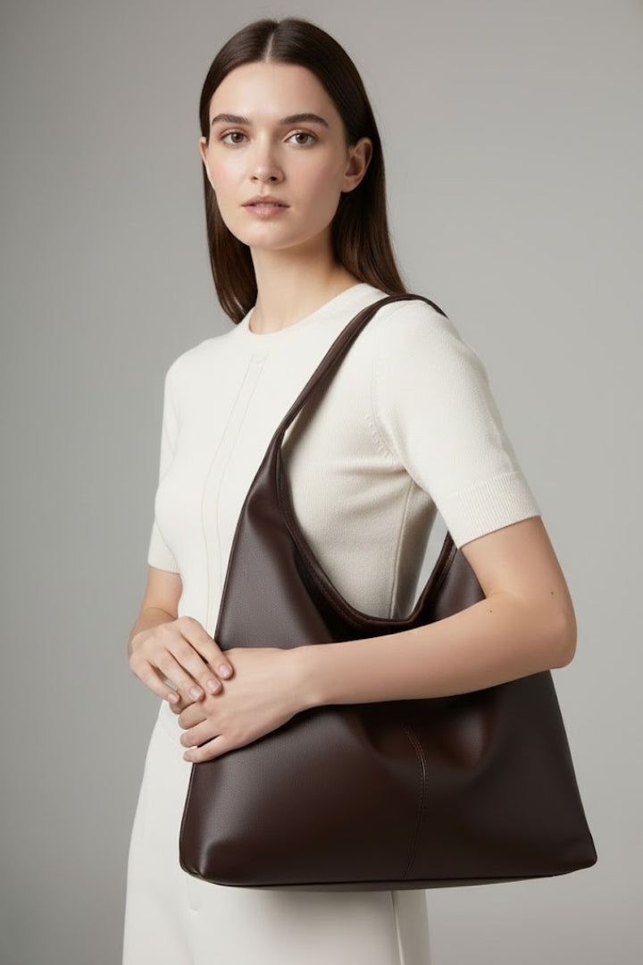 Inside view of a large capacity women's tote bag, showing the organized compartments of a work bag.
