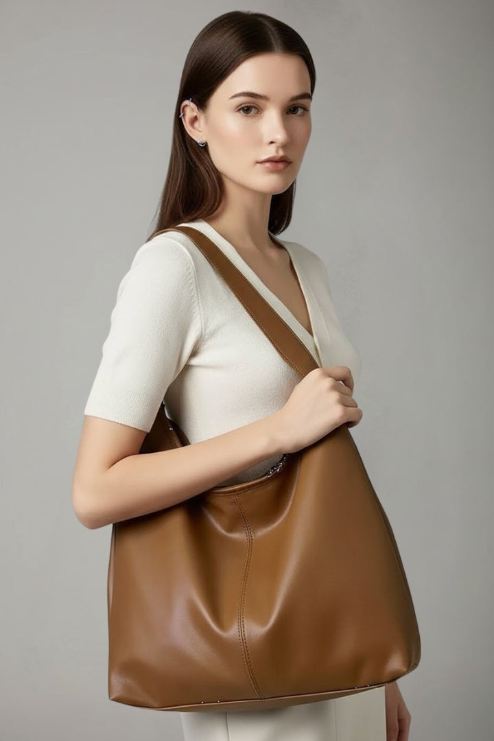 Back view of a classic faux leather tote bag, highlighting its smooth finish and clean lines as a shoulder bag.
