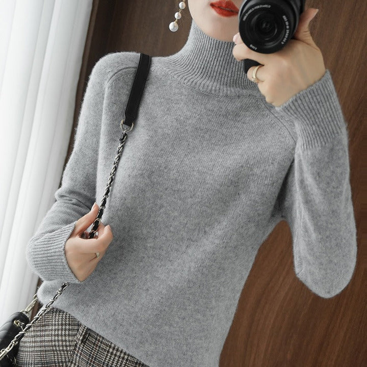 Minimalist women's turtleneck sweater for winter style. Smooth knit pullover, perfect for layering.