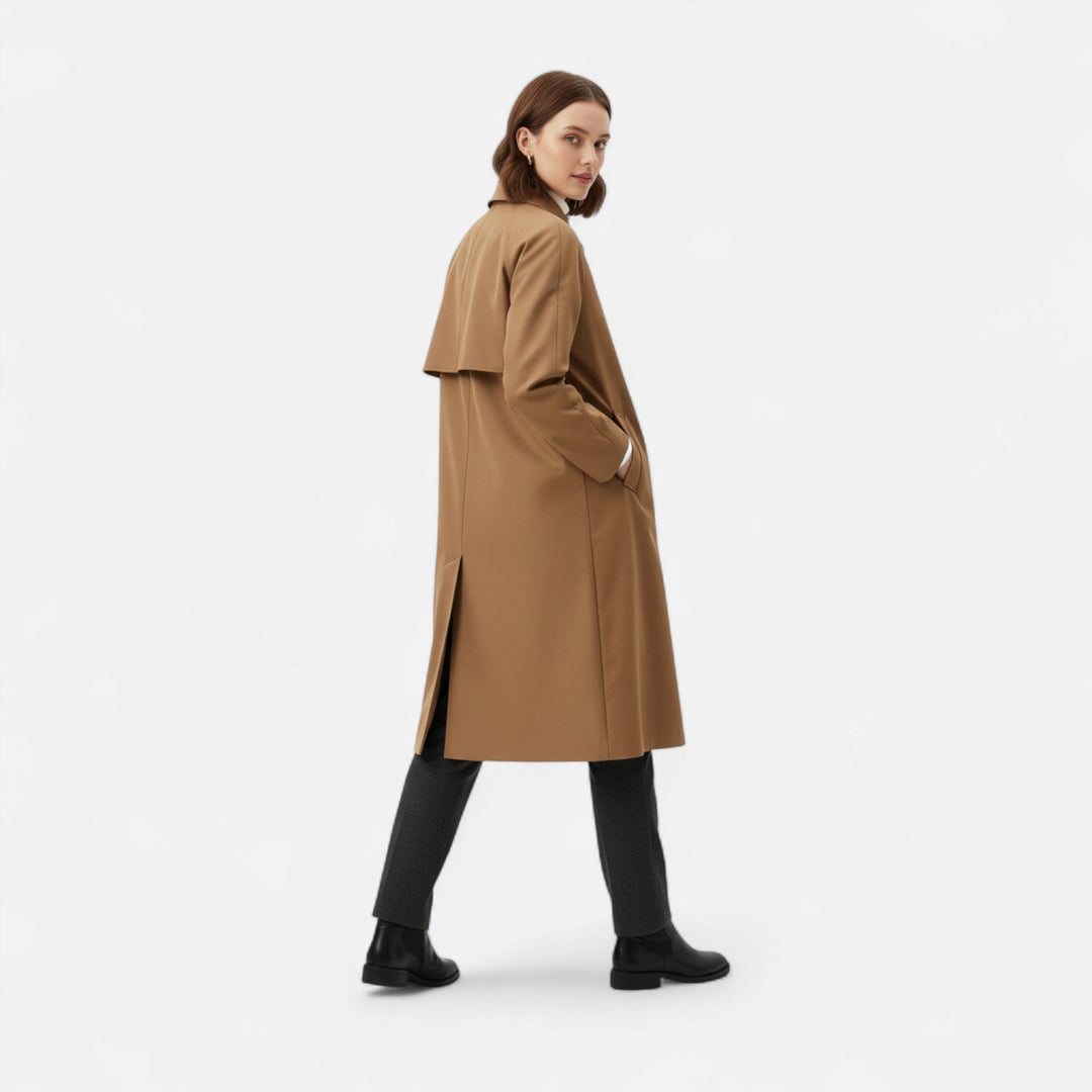 Chic black long trench coat for women, featuring a loose fit & retro style. Ideal for formal or everyday wear.