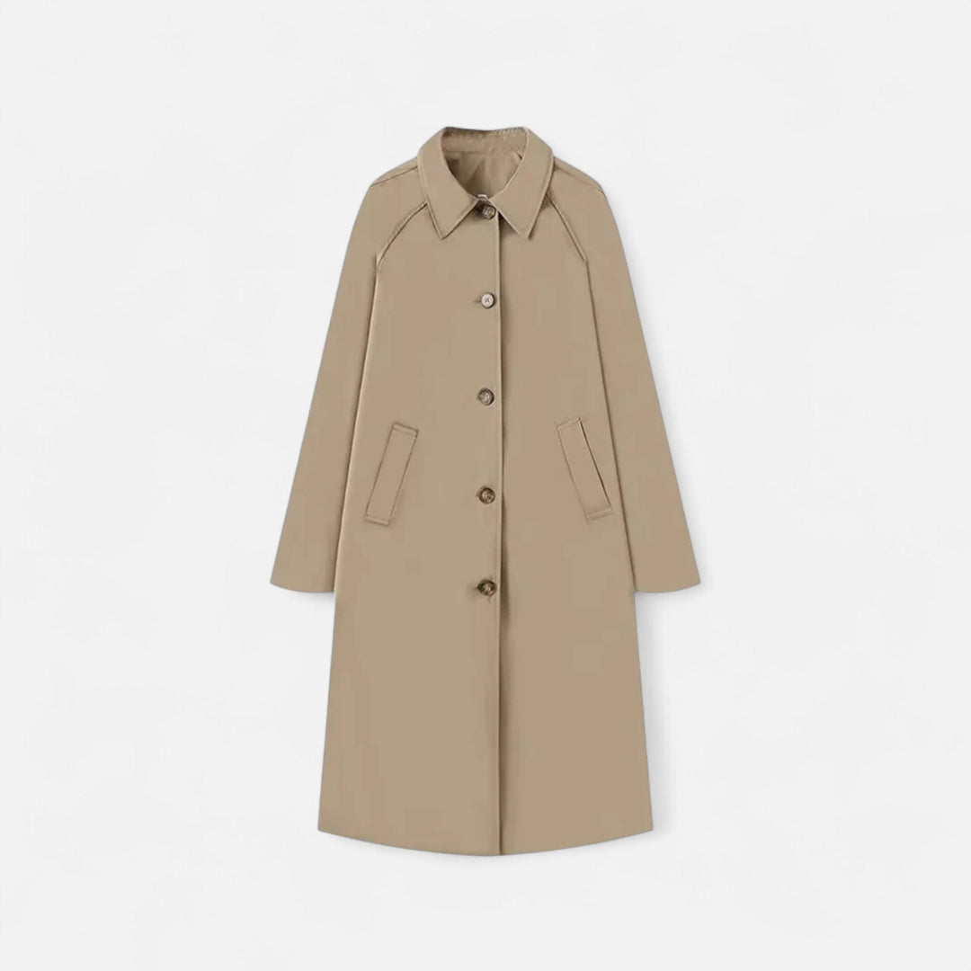 Loose fit single-breasted women's long trench coat in a classic retro style. Effortless everyday elegance.