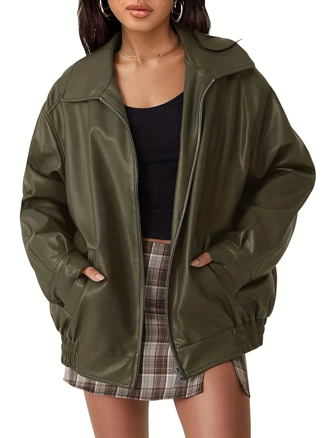 Side profile of a woman wearing a classic oversized black bomber jacket, showcasing the fit and design