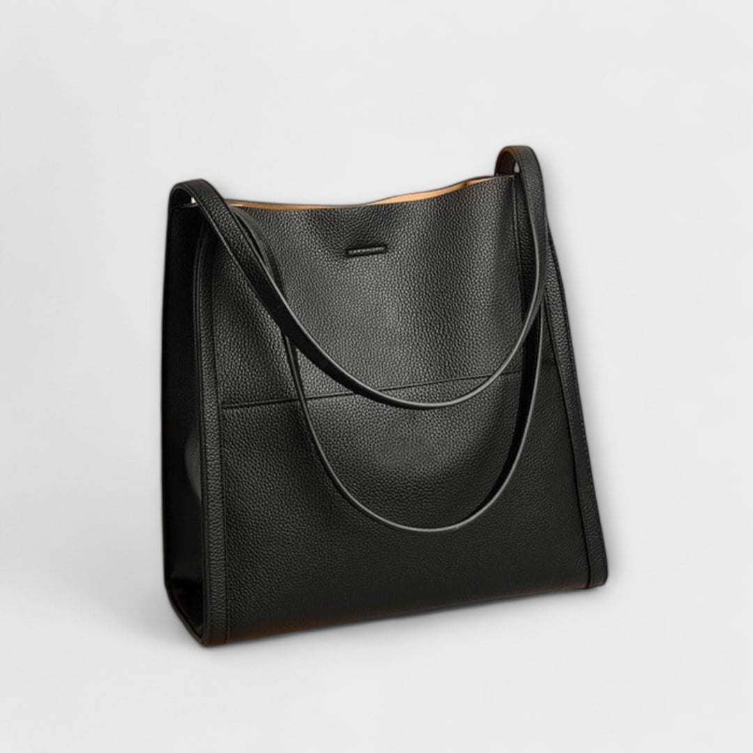 Women's classic structured shoulder bag paired with an evening dress, a stylish elegant bag.