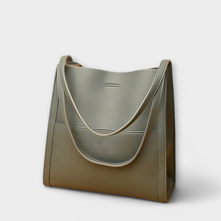 Side profile of women's classic structured faux leather handbag, ideal for work.