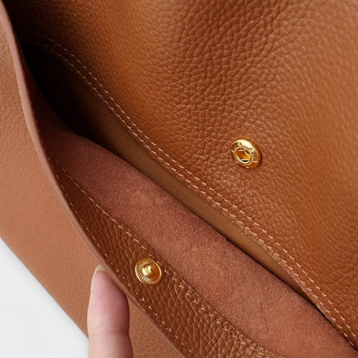 Women's classic structured shoulder bag in a neutral color, a chic everyday accessory.